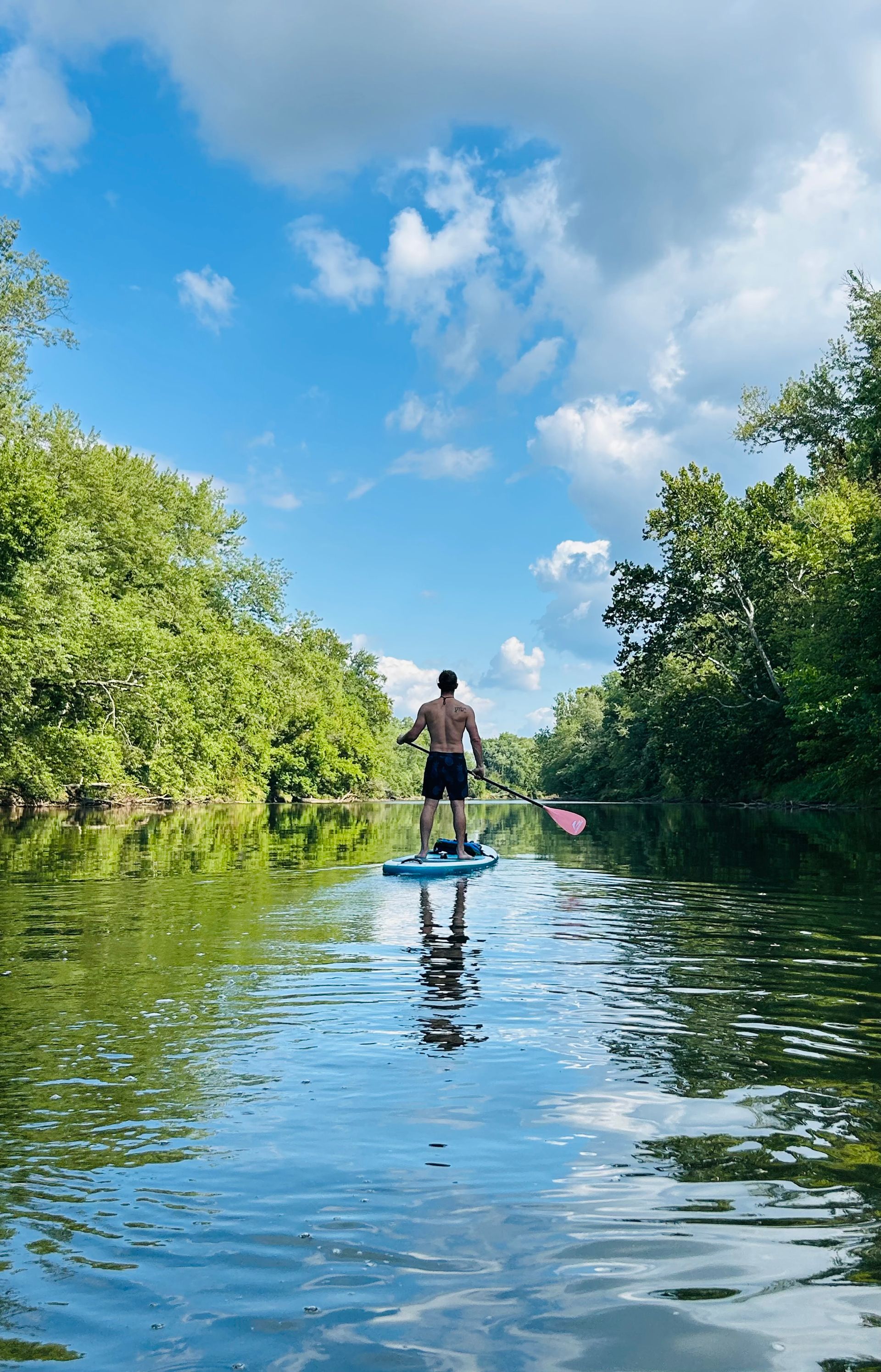Clint paddleboarding on a river
